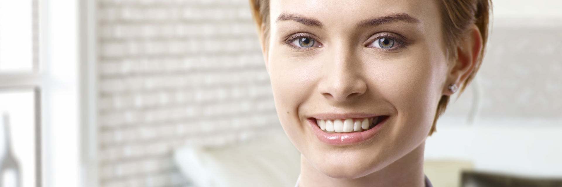 Happy young woman showing her nice teeth in a smile.