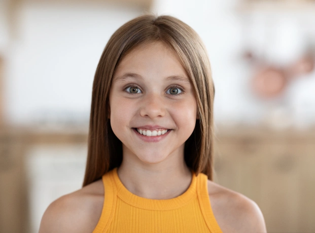 Smiling child with healthy teeth at a children’s dentistry clinic in Alpharetta.