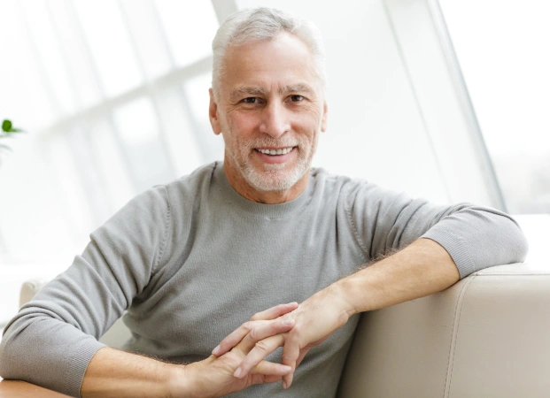 Happy senior patient with a relaxed smile, highlighting long-term oral wellness.
