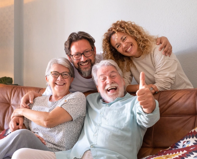 Portrait of a happy family giving a thumbs-up to their Alpharetta dental provider.