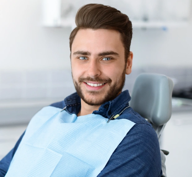 Patient relaxing in dental chair during TMJ treatment for jaw pain relief.